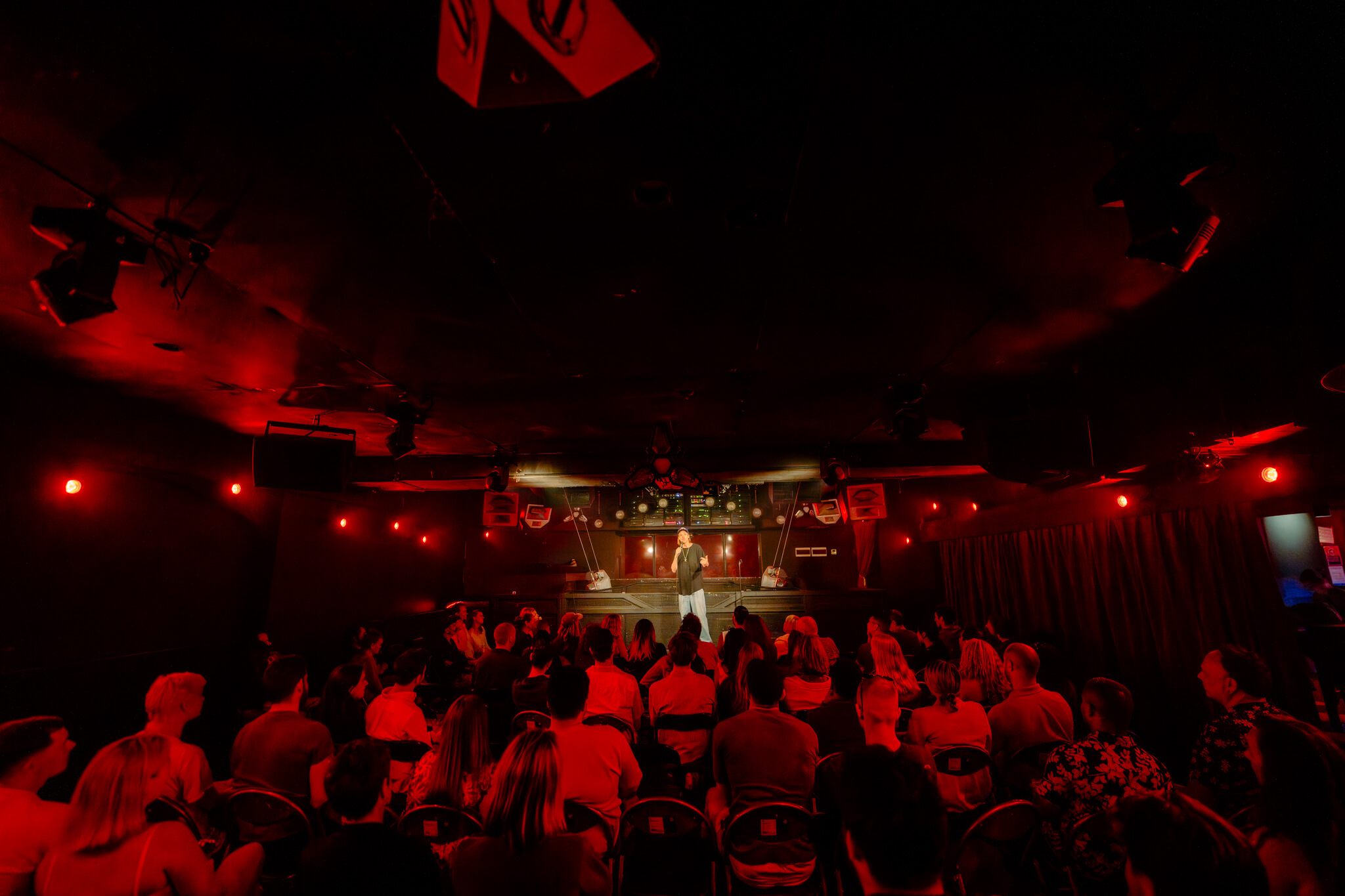 A packed Carousel Bar & Ballroom ballroom watching a comedian on stage